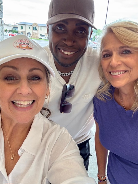 Mel and guests smiling together at a Mel's Minis event