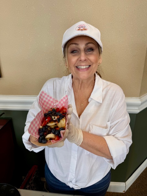 Mel holding a freshly made serving of Mel's Minis mini pancakes